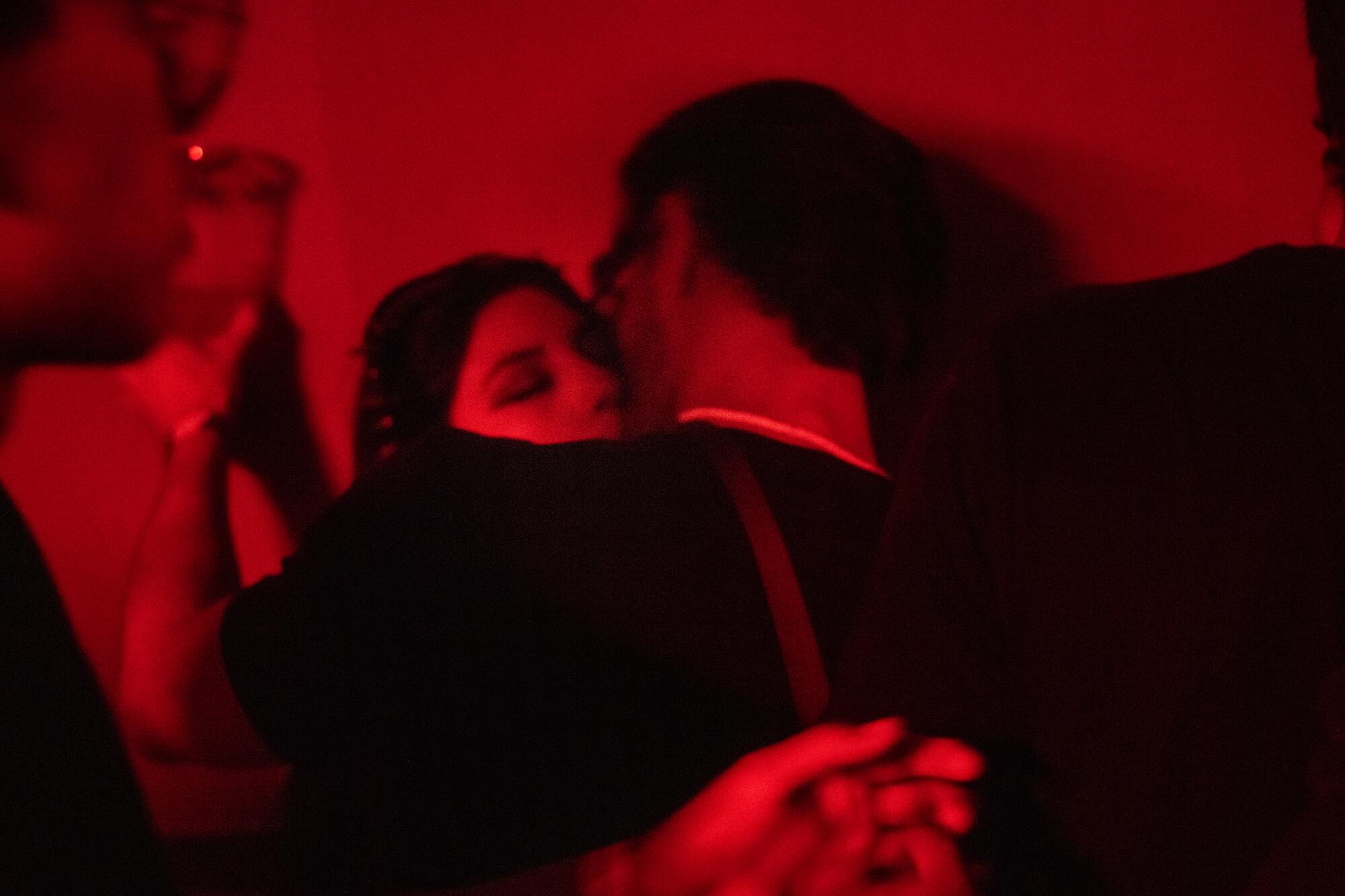 Patrons kiss at the Japan Bar