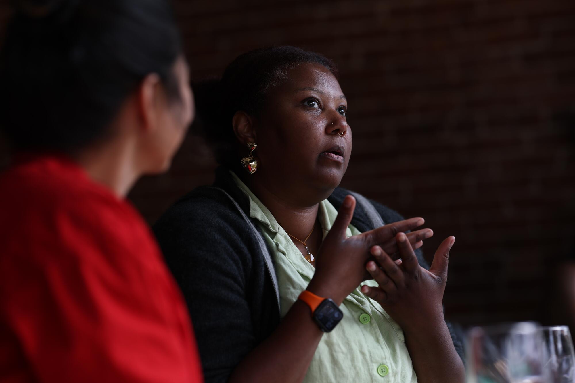 A woman gestures while discussing the California governors race