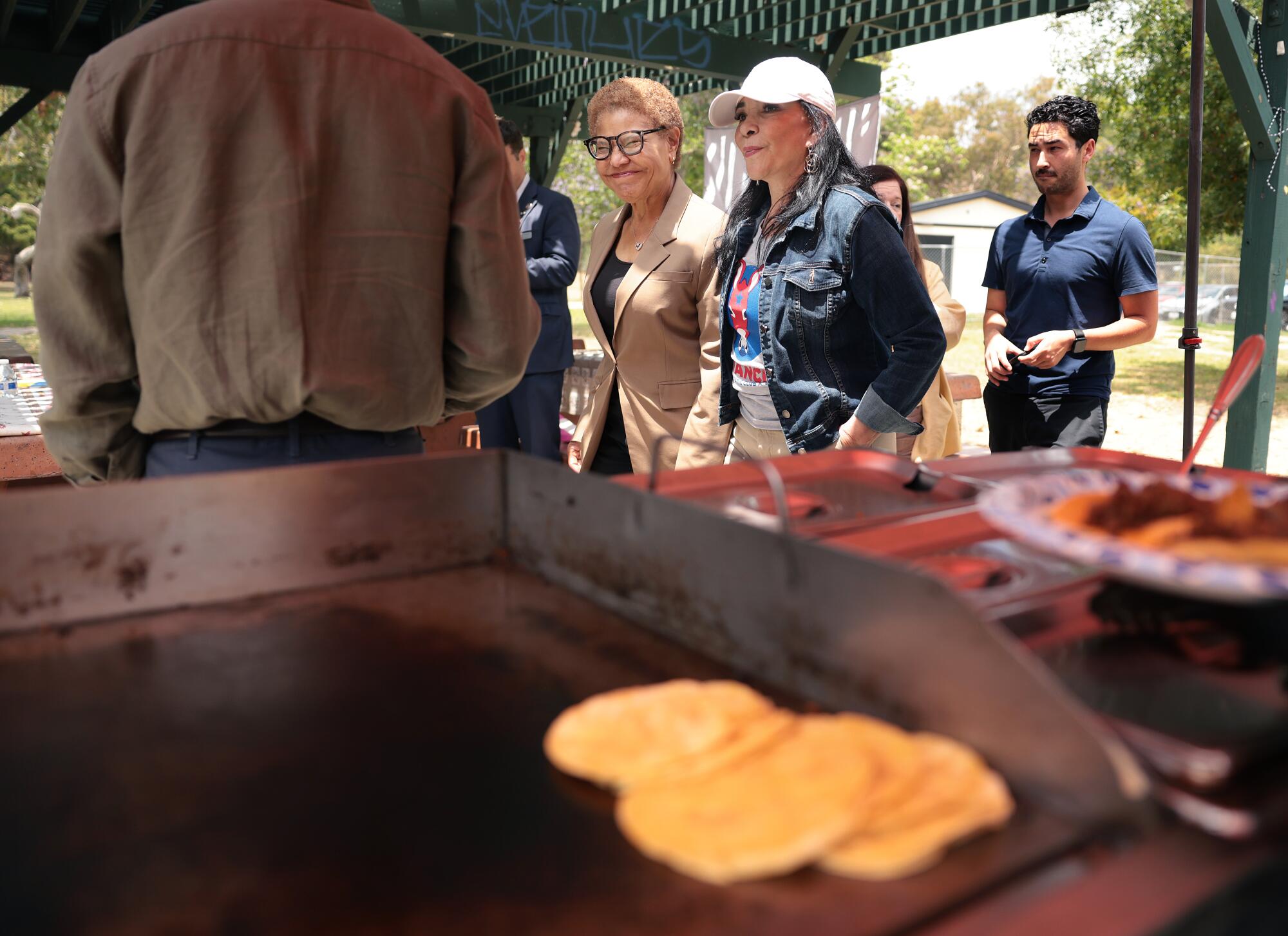 Mayor Karen Bass walks with Nilza Serrano during Avance's politics and tacos event
