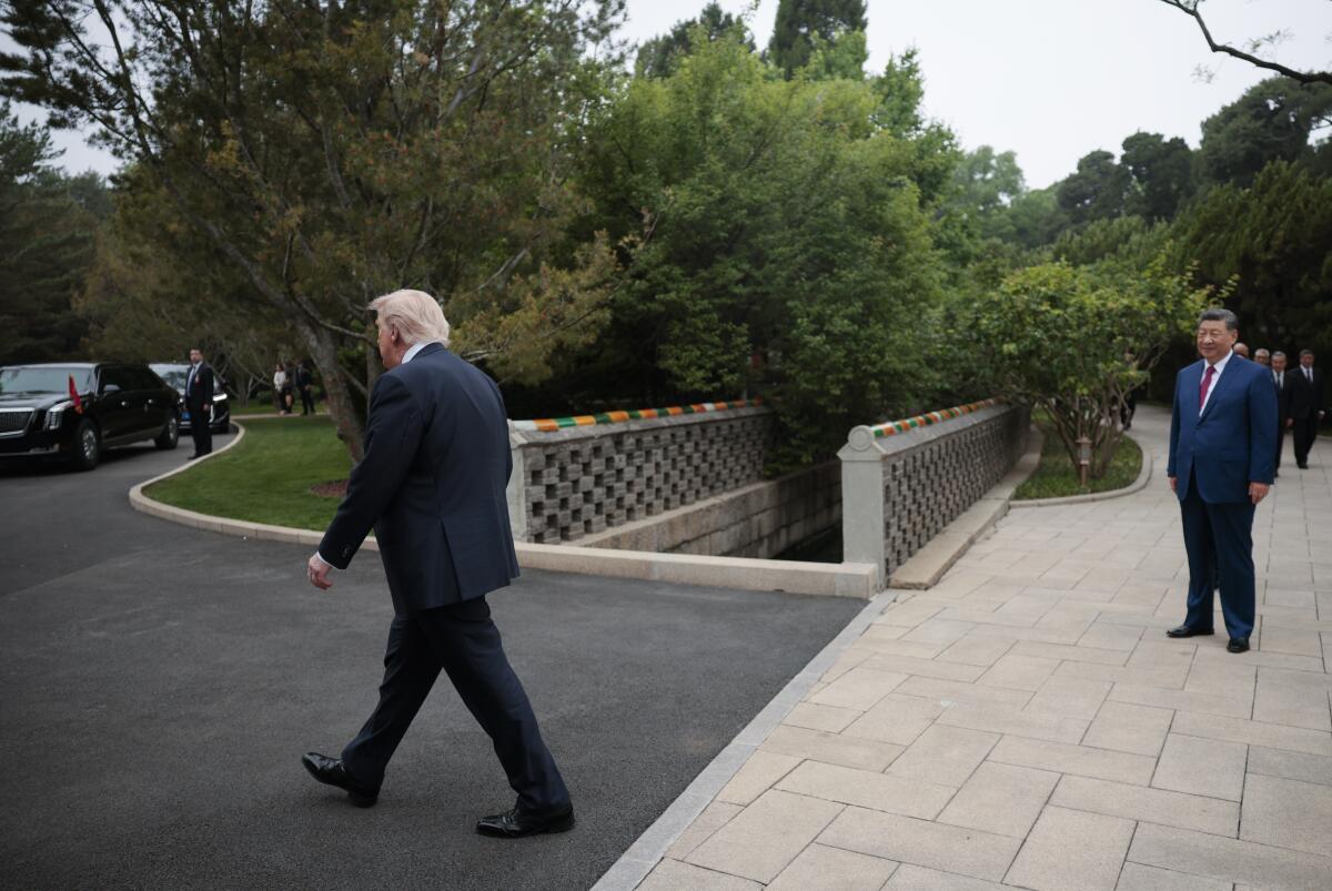 President Trump departs as President Xi looks on after a visit to Zhongnanhai Garden on Friday.
