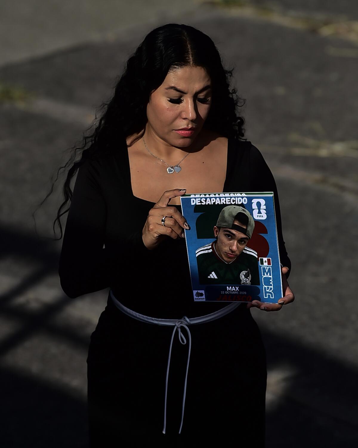 a mother poses with a search card