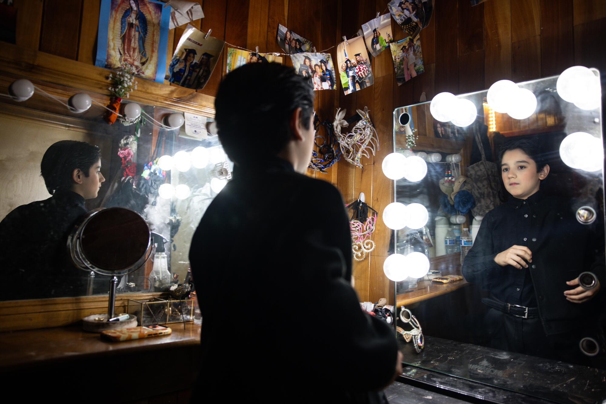 Francesco Caballero, 13, gets ready in a mirror inside a trailer at the Caballero Circus.