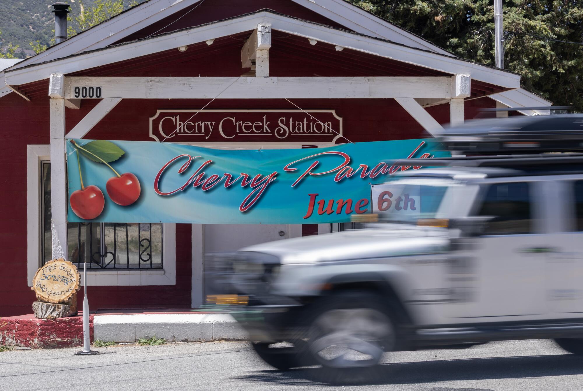 A sign outside Cherry Creek Station advertises the Leona Valley Cherry Parade on June 6. 