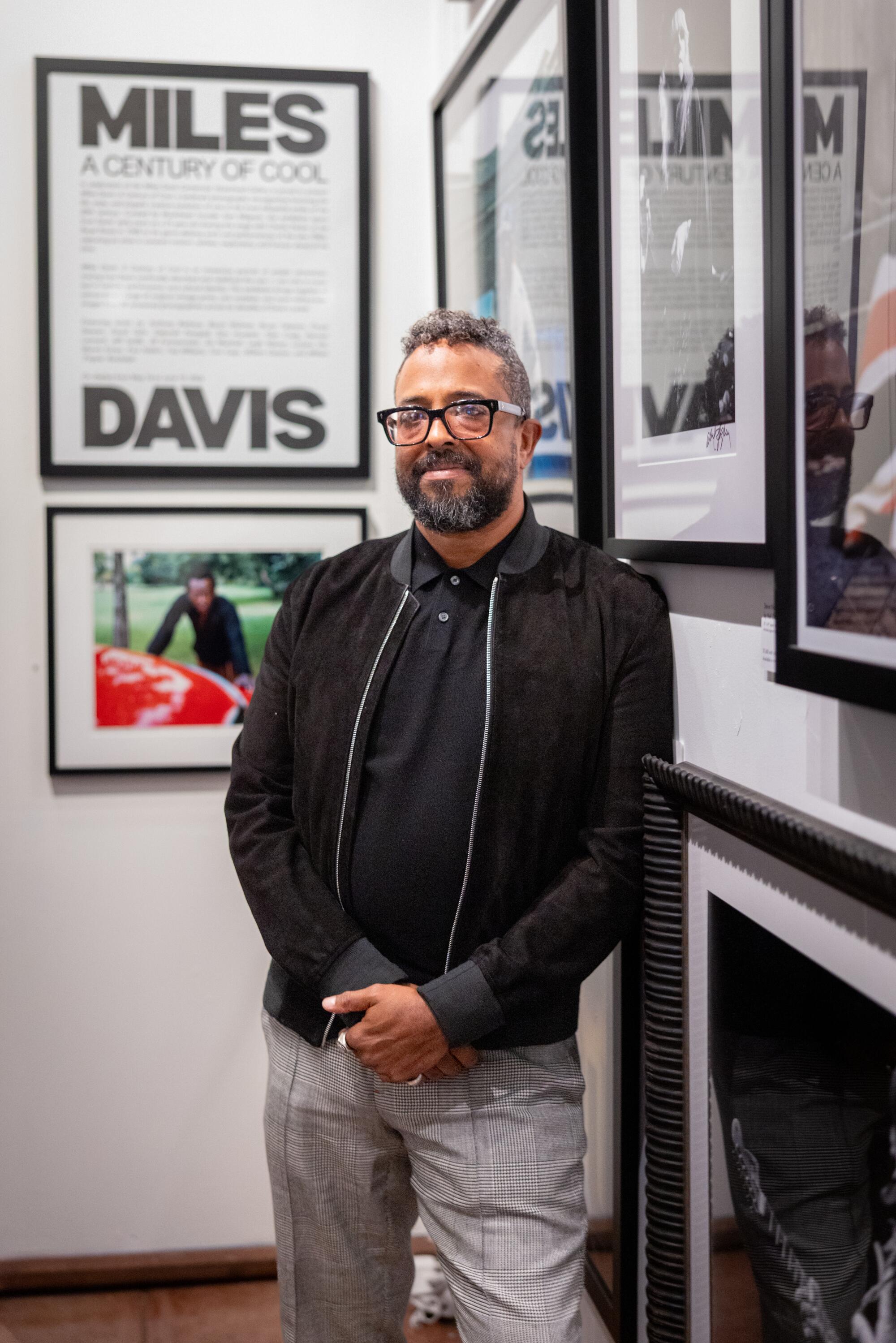 Erin Davis, son of Miles Davis, wears a black jacket and gray pants while he poses for a portrait at Musichead Gallery.