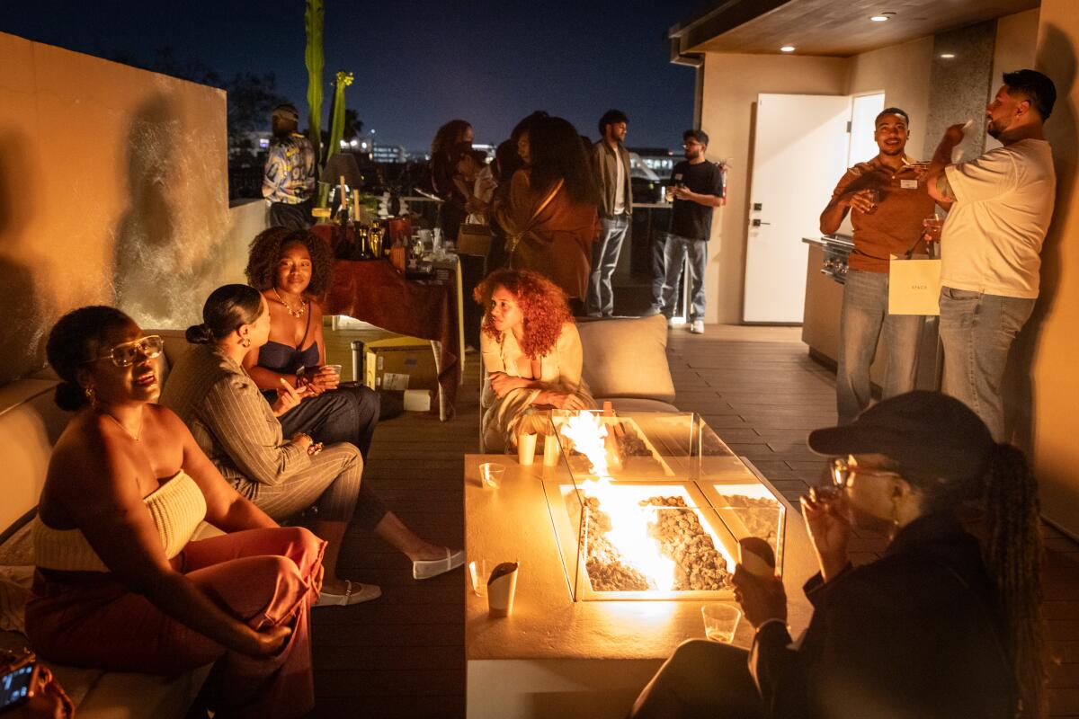 Fragrance lovers hang out on the rooftop at Smellers Club's West Hollywood gathering.