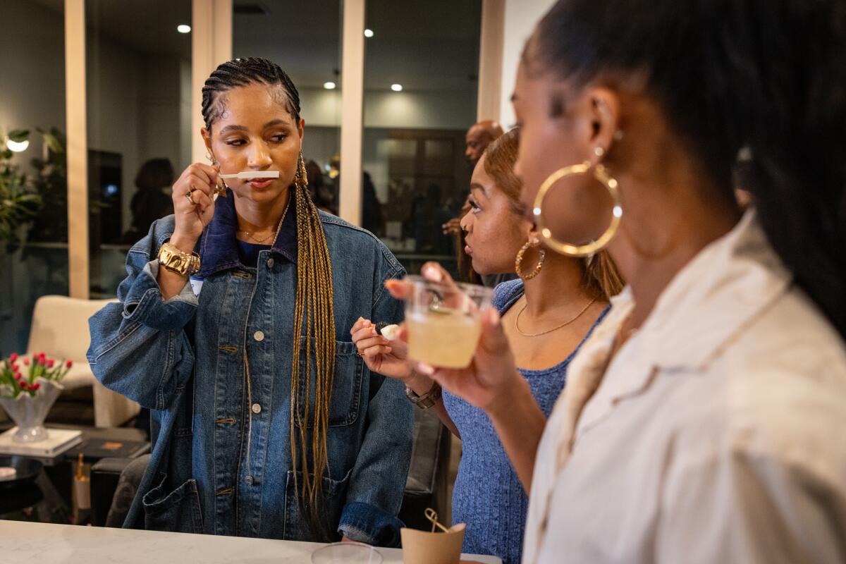 Sarah Bowen, co-founder of the Smellers Club, sniffs a fragrance.