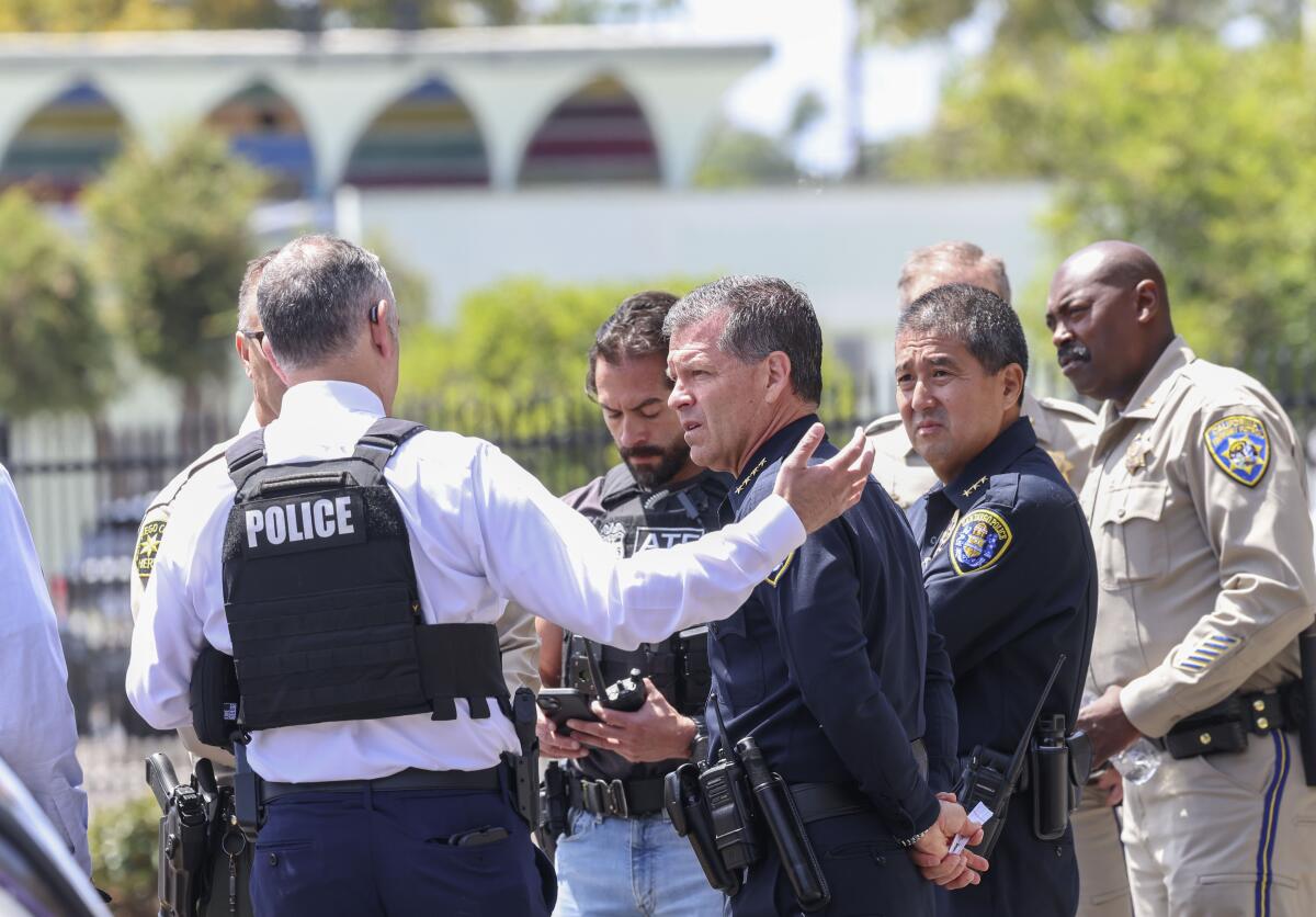 San Diego Police officials gather outside of the Islamic Center of San Diego 
