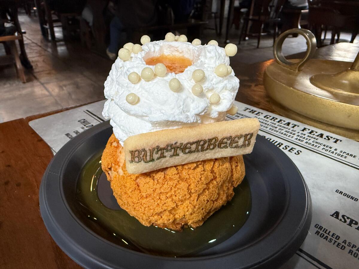 A decadent puffy dessert with lots of cream on top of a pastry. 