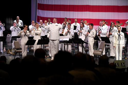 Lt. Joel Davidson directs the Navy Band Southwest performs as...