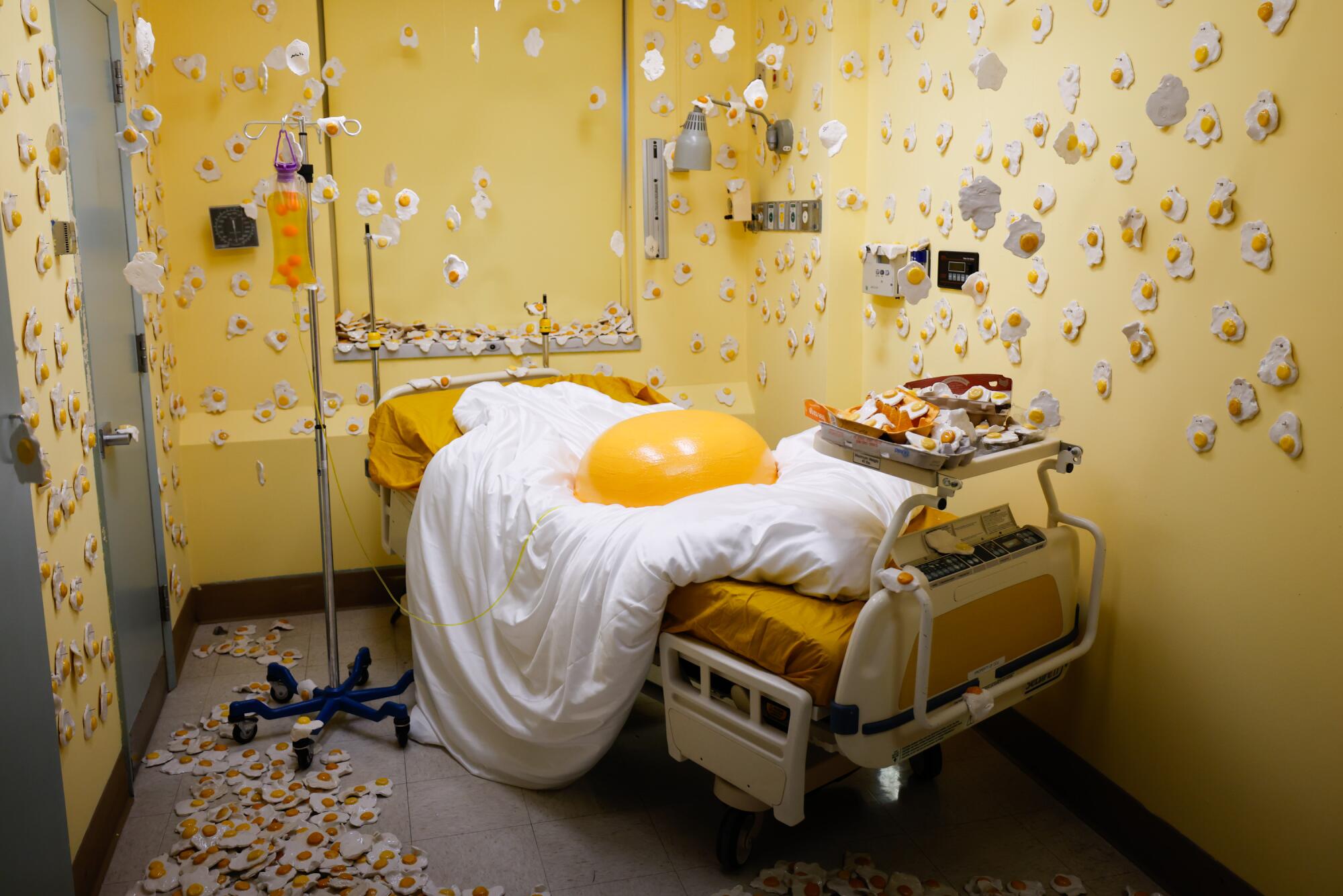 A giant egg in a hospital bed is part of an immersive art installation.