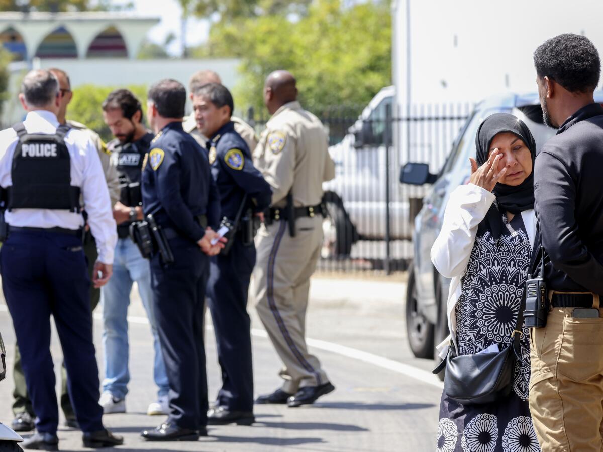 A woman weeps outside the Islamic Center of San Diego