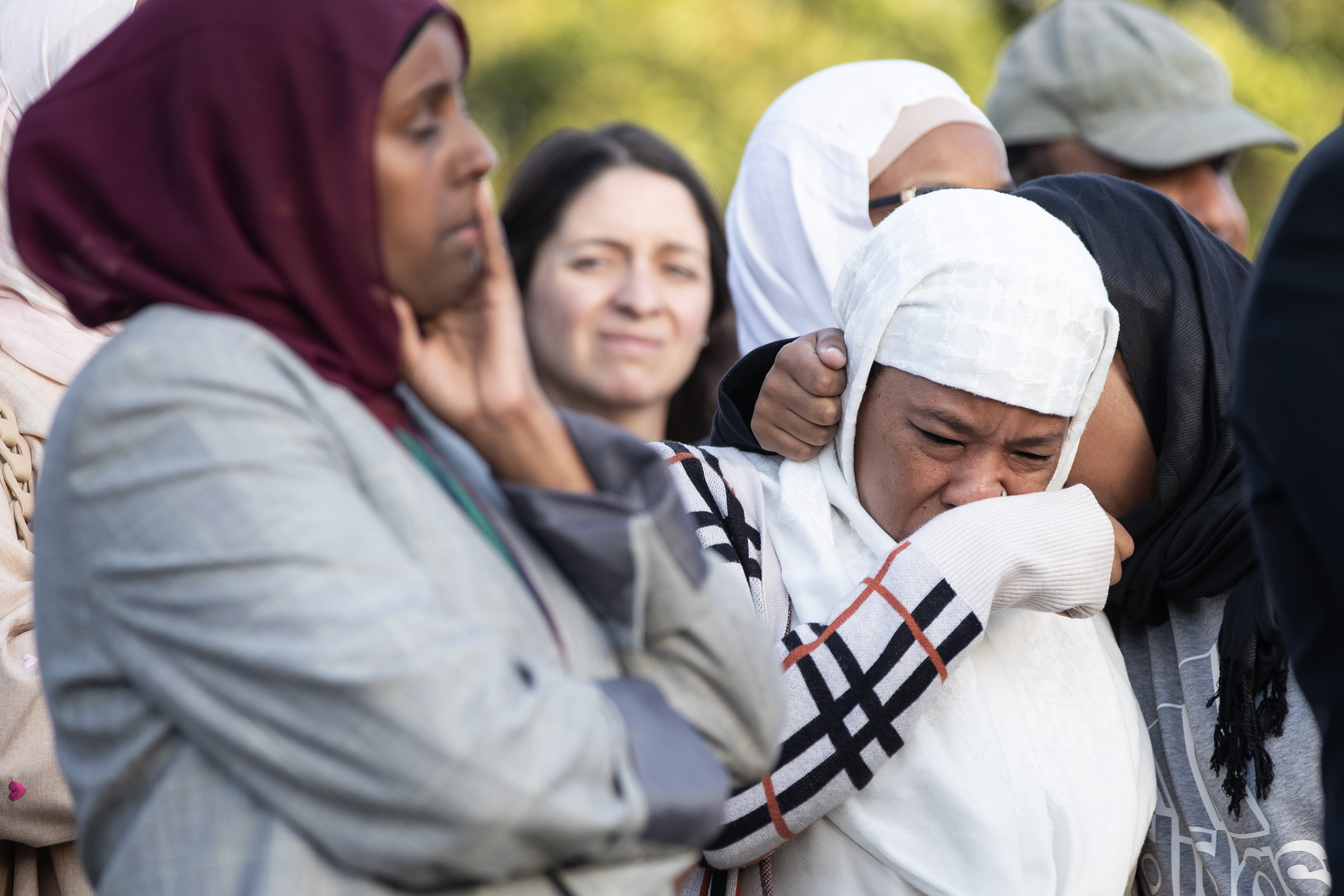 San Diego, CA – People react to speakers during an...