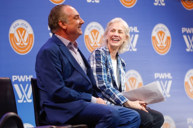 Jonathan Becher, president of Sharks Sports & Entertainment, and Amy Scheer, Senior Vice President of Business Operations for the Professional Women's Hockey League, laugh during a press conference announcing San Jose's Professional Women's Hockey League team in San Jose at SAP Center in San Jose, Calif., on Tuesday, May 19, 2026. (Shae Hammond/Bay Area News Group)