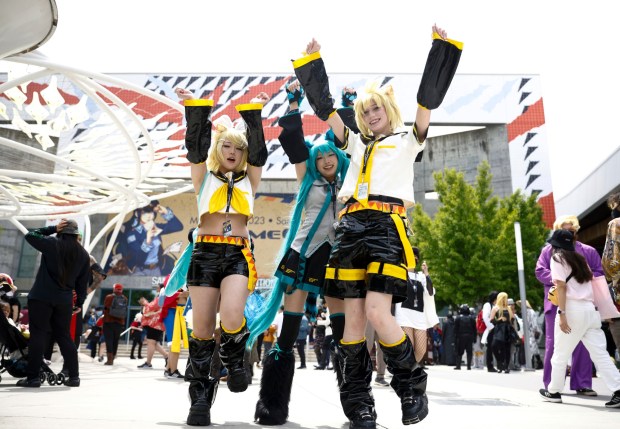 (Left to right) Selina Wei, of San Francisco dressed as Kagamine Rin, Alyssa Yin, of San Francisco dressed as Hatsune Miku, and Lucie Warren, dressed as Kagamine Len of San Francisco, record a TikTok at FanimeCon at San Jose McEnery Convention Center in San Jose, Calif., on Sunday, May 28, 2023. (Shae Hammond/Bay Area News Group)