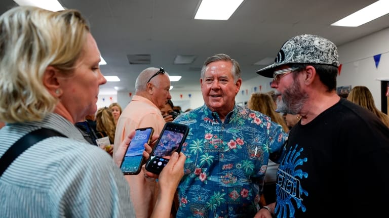 Rep. Ken Calvert, R-Calif., speaks with constituents at a "Barbeque,...