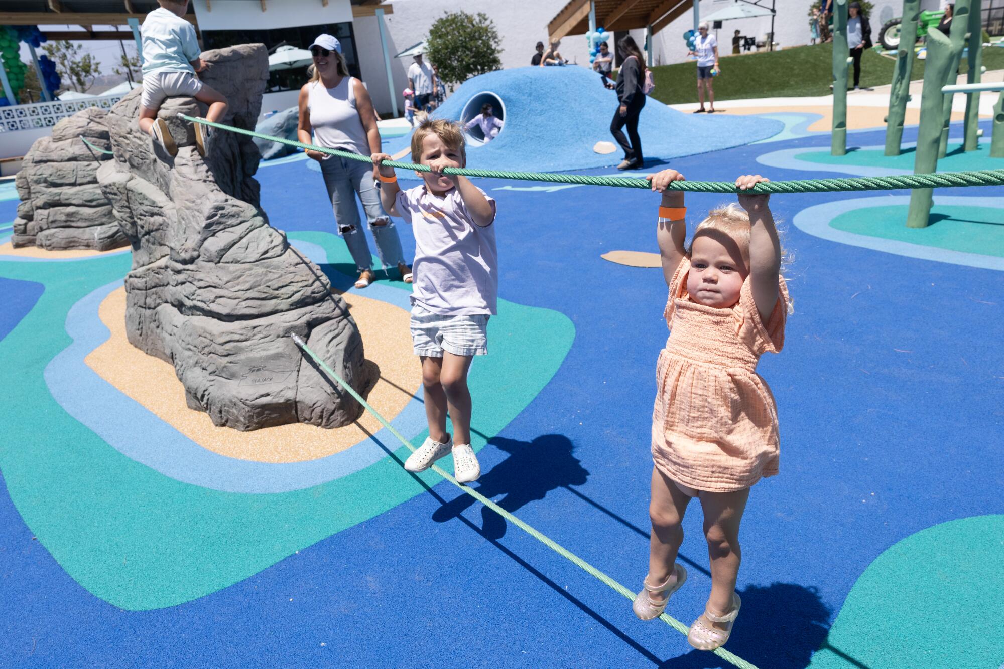Avery Hanchar, right, and her brothers Oliver and Carter, test their climbing and balancing skills.