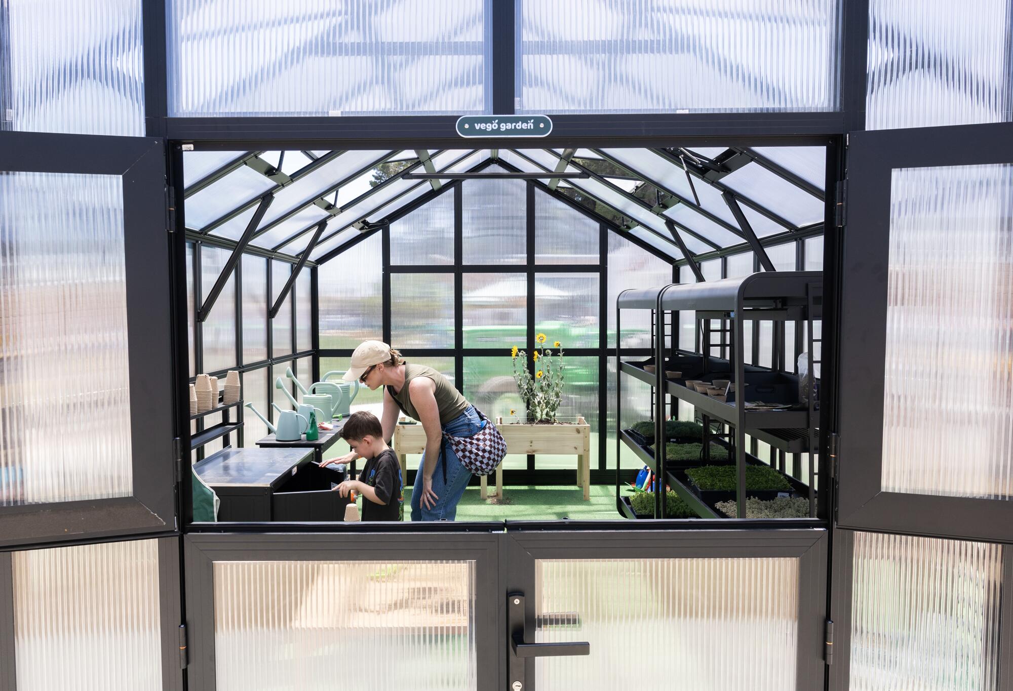 Visitors walk through a greenhouse at the museum's agriculture area.