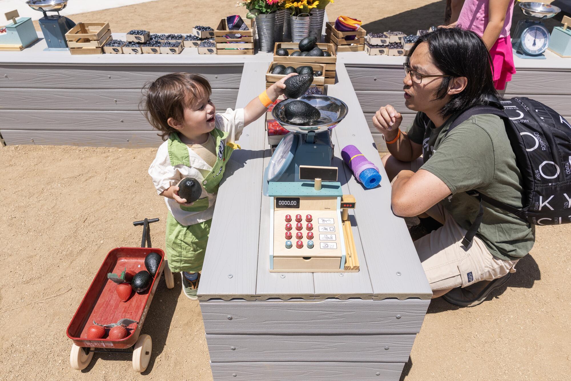 Luke Delossantos, right, and his son Grayson play pretend.