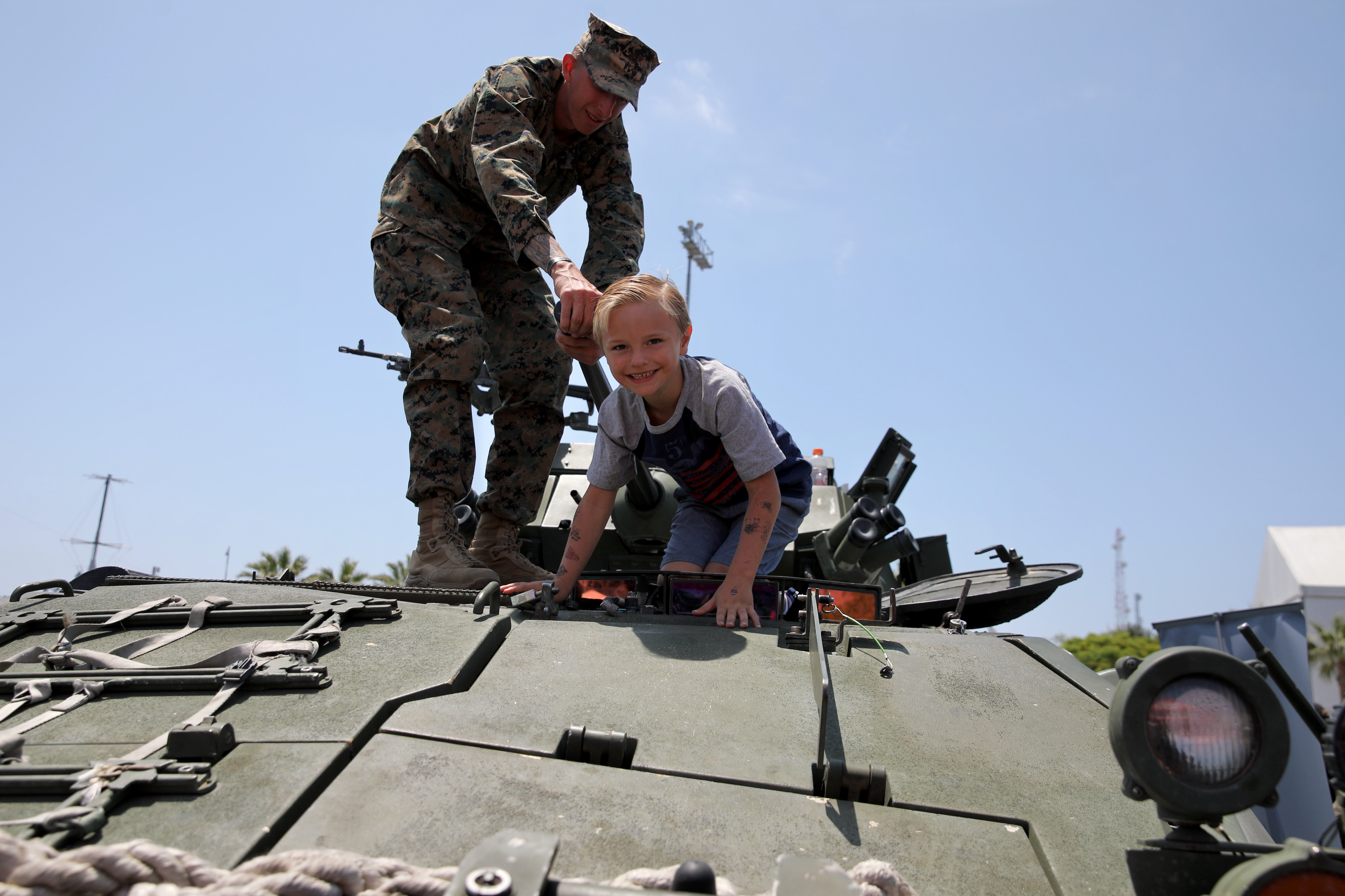 A marine helps Dominick Cunningham, 6, of Corona climb out...