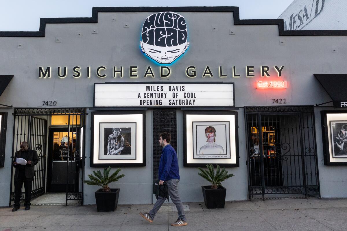A person walks outside Musichead Gallery.