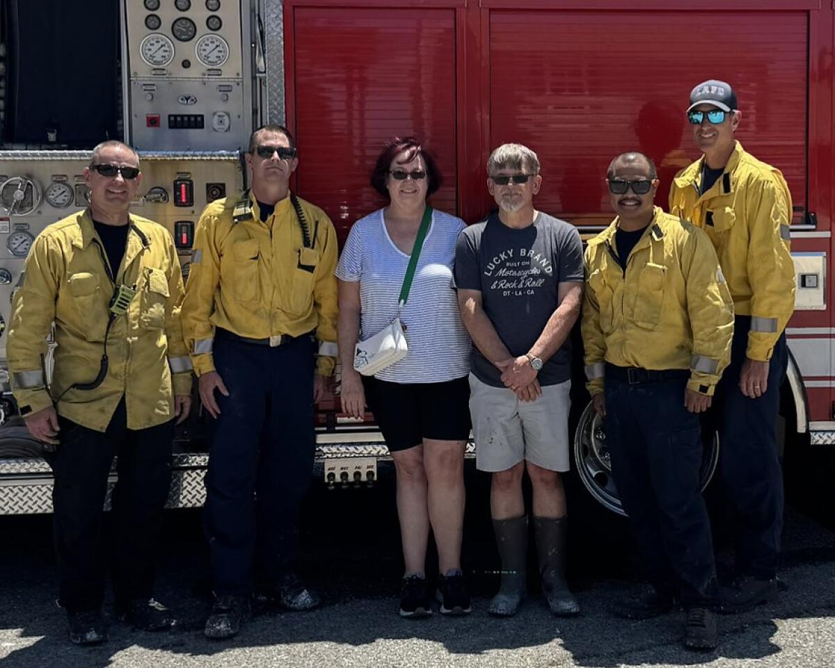 Los Angeles firefighters posing with a Simi Valley woman