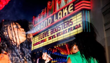 A woman smokes in front of the Grand Lake Theatre marquee before a showing of “I Love Boosters” at the Grand Lake Theatre in Oakland, Thursday, May 21, 2026.