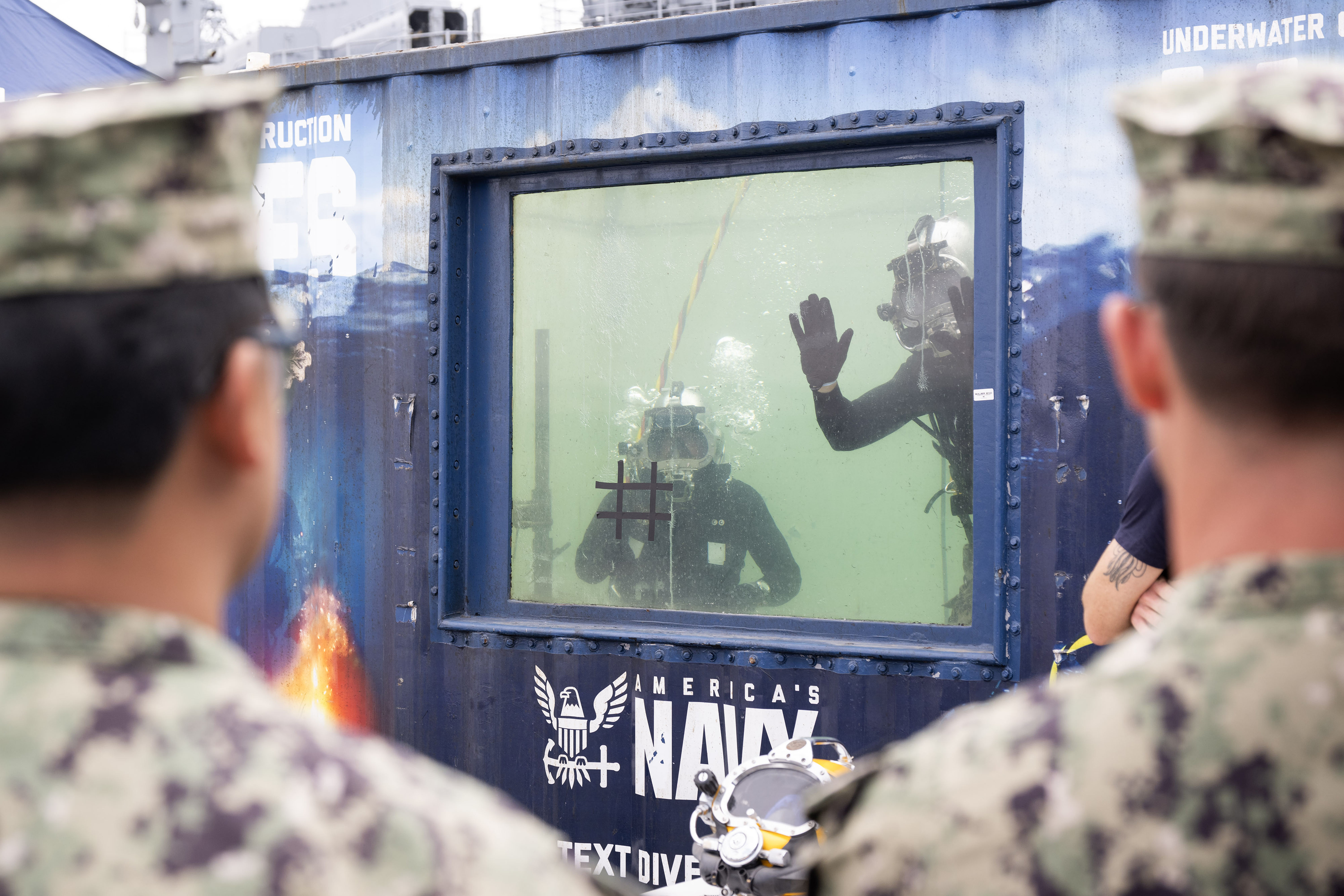 Members of the Seabee Divers wave to attendees of the...