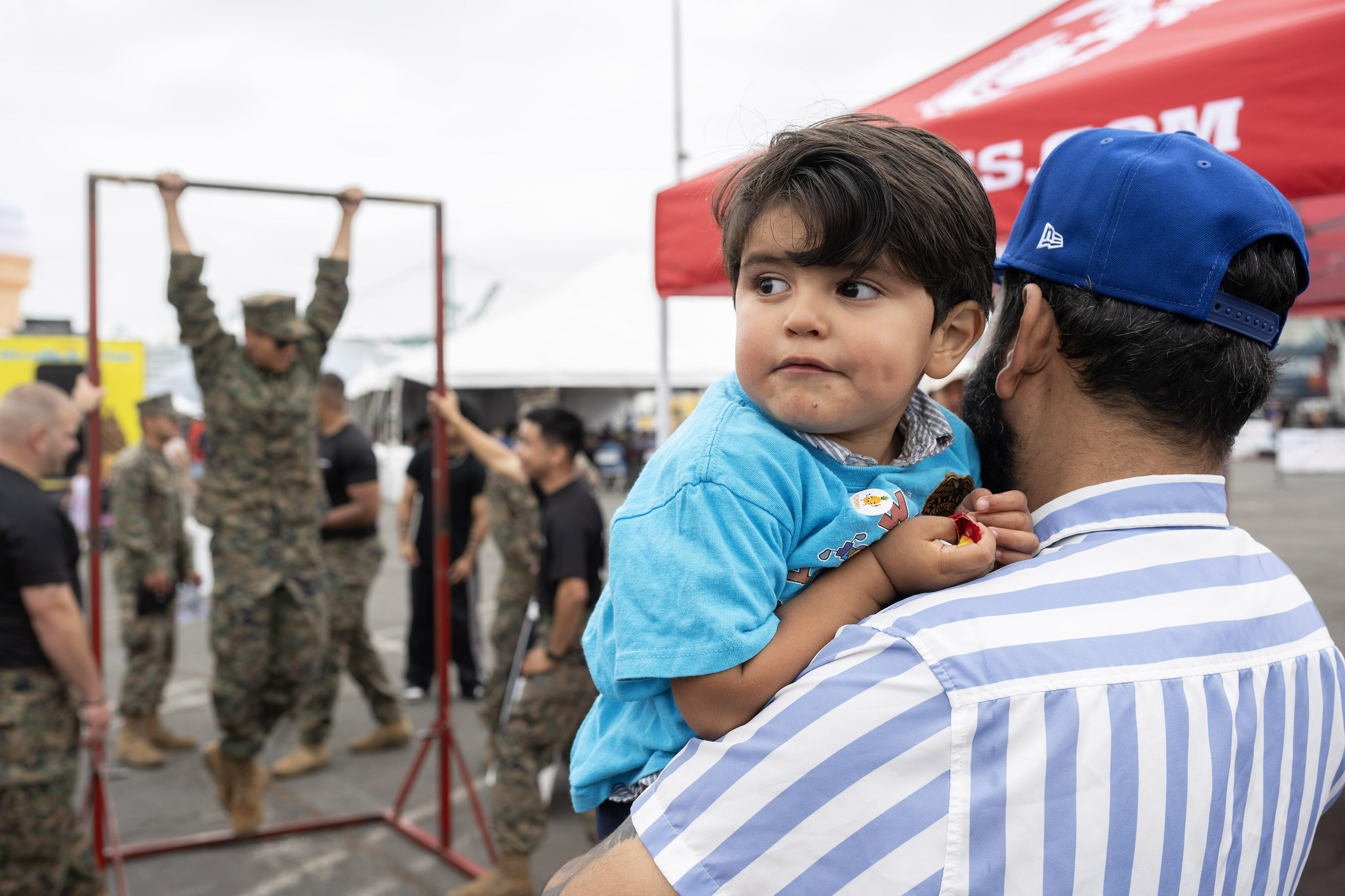 From right, Jose Alonzo and two-year-old Benjamin Alonzo attend day...