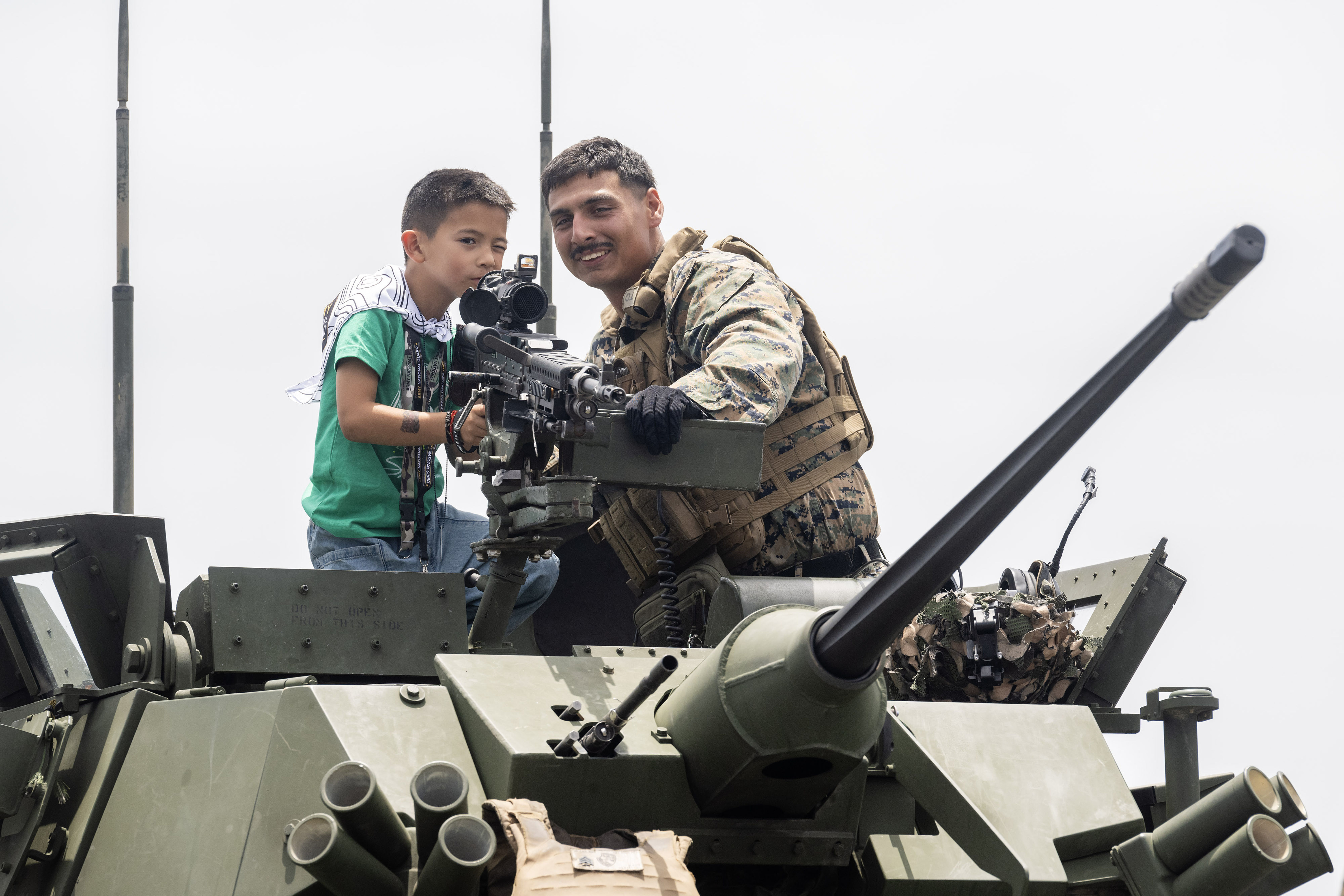 From right, Lance Corporal Joseph Wiwakan teaches six-year-old Mattson Marsteller...