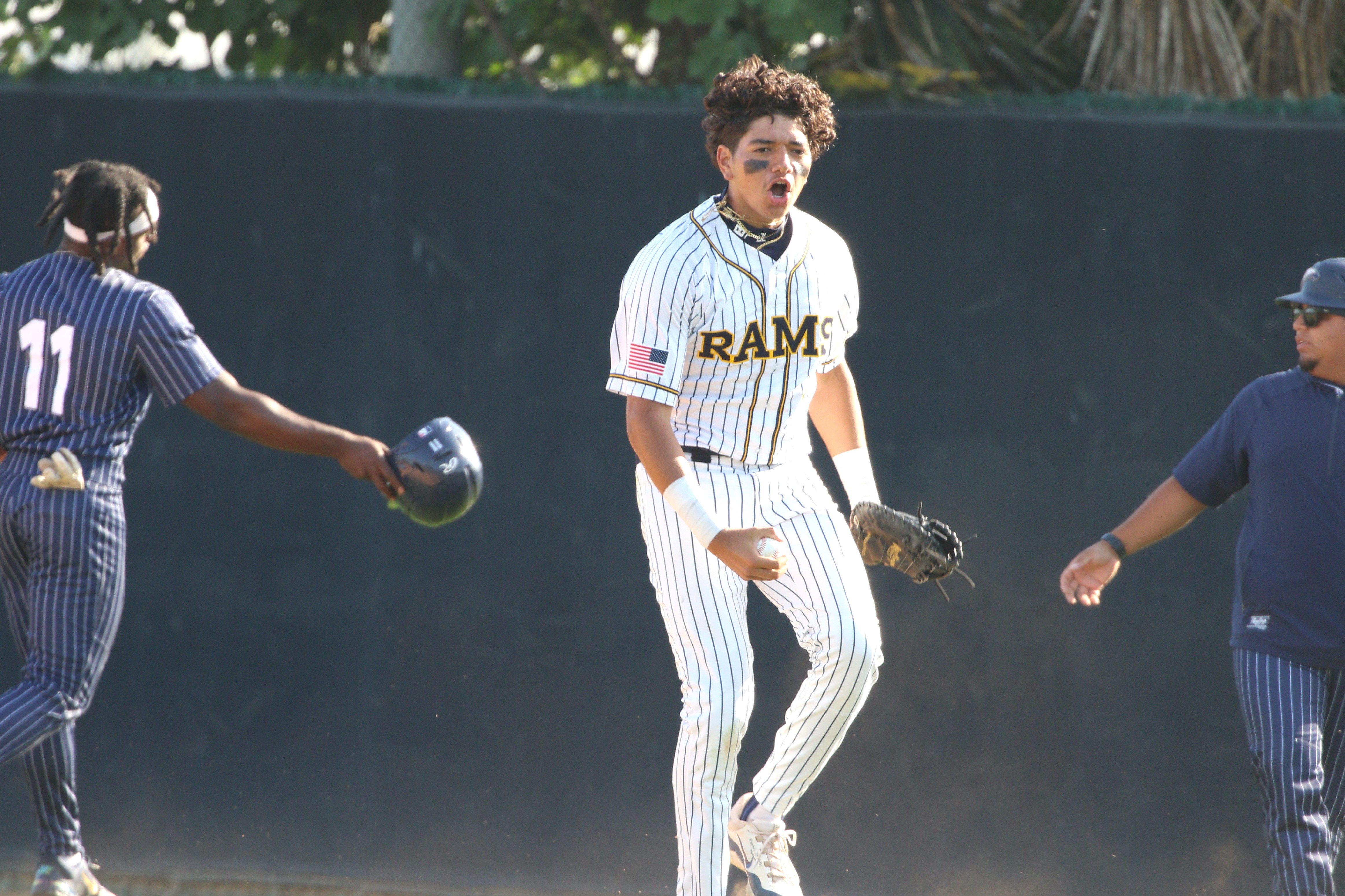 Millikan first baseman AJ Nonato jumps with emotion after his...