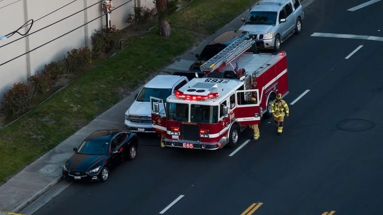 Firefighters work at the scene of a chemical tank that...