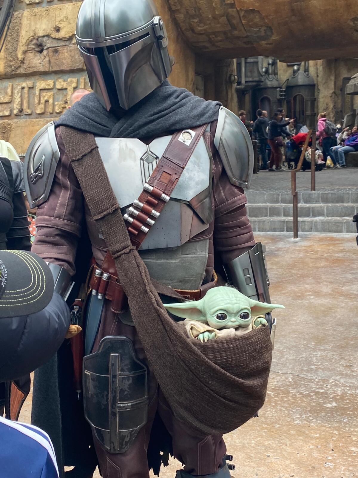 The Mandalorian and Grogu at Star Wars: Galaxy’s Edge in Disneyland.