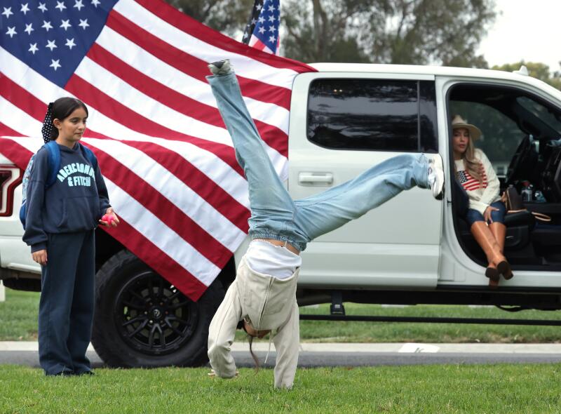 Kendrie Azcarate center, does a cartwheel as her friend Ava and mom Nina look on.