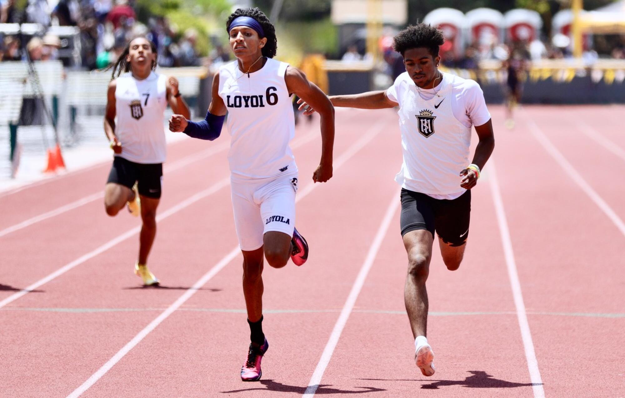 Loyola’s Ejam Yohannes beats Servite’s Jaelen Hunter by 11 hundredths of a second in the 400-meter dash.