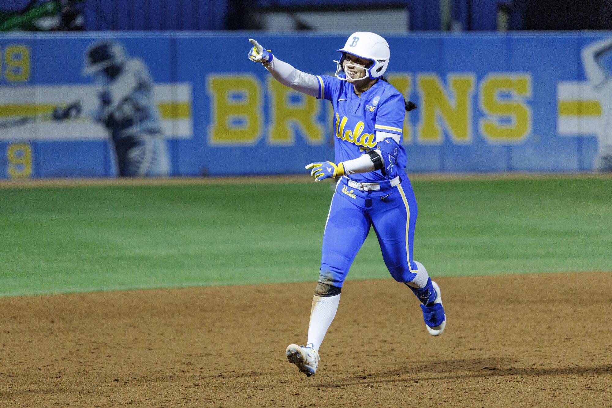 UCLA infielder Bri Alejandre points toward the dugout after hitting the team's 200th homer of the season against UCF.