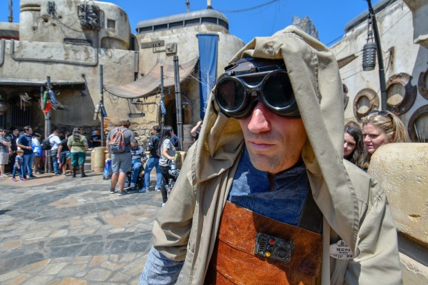 A scrap metal dealer keeps an eye on the line to build custom lightsabers at Savi's Workshop on opening day at Star Wars: Galaxy's Edge at Disneyland in Anaheim, CA, on Friday, May 31, 2019. (Photo by SCNG)