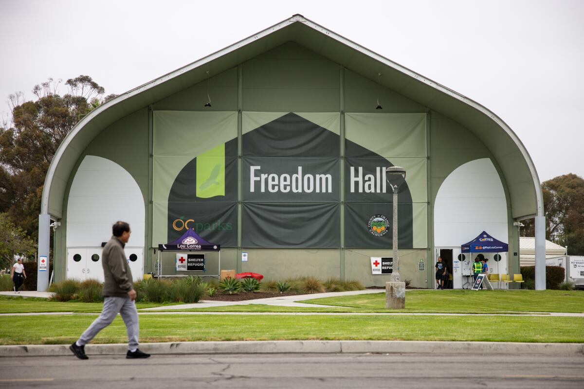 A man walks past the Freedom Hall shelter on Sunday in Garden Grove.