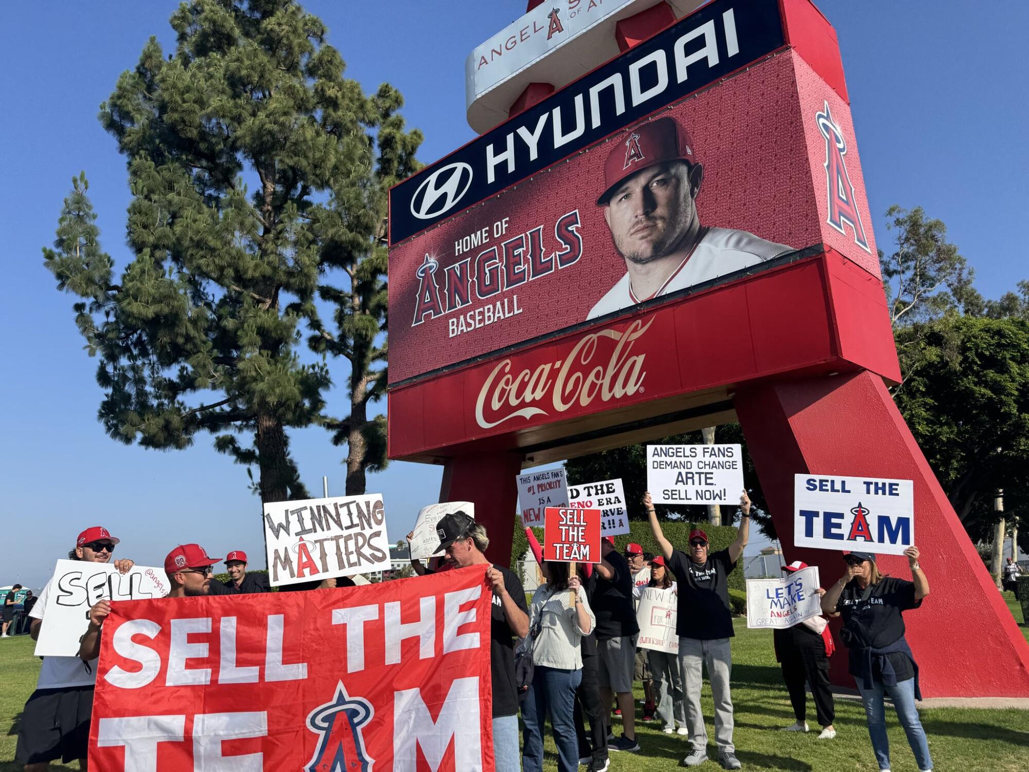 Angels fans wave signs and urge owner Arte Moreno to sell the team during a recent protest at Angel Stadium.