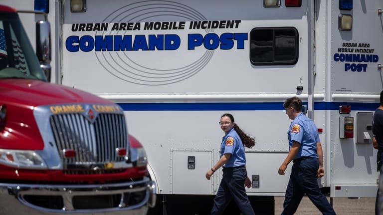 Emergency personnel work at the incident command post at the...