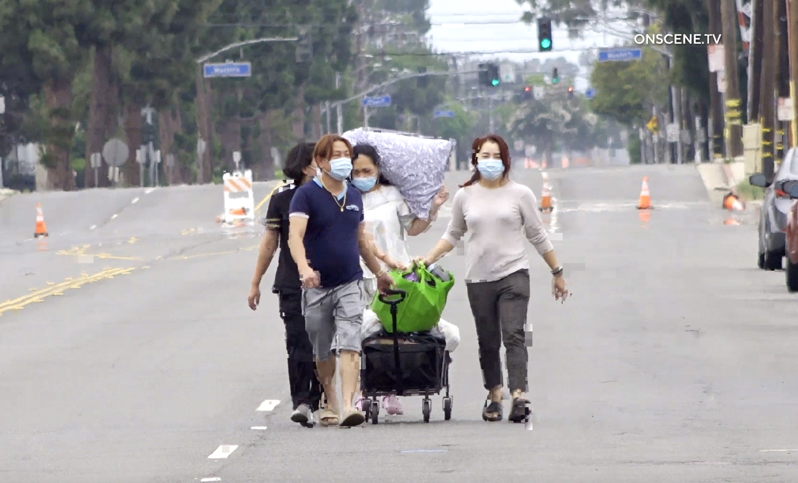 People walk with their belongings in the evacuation area in...