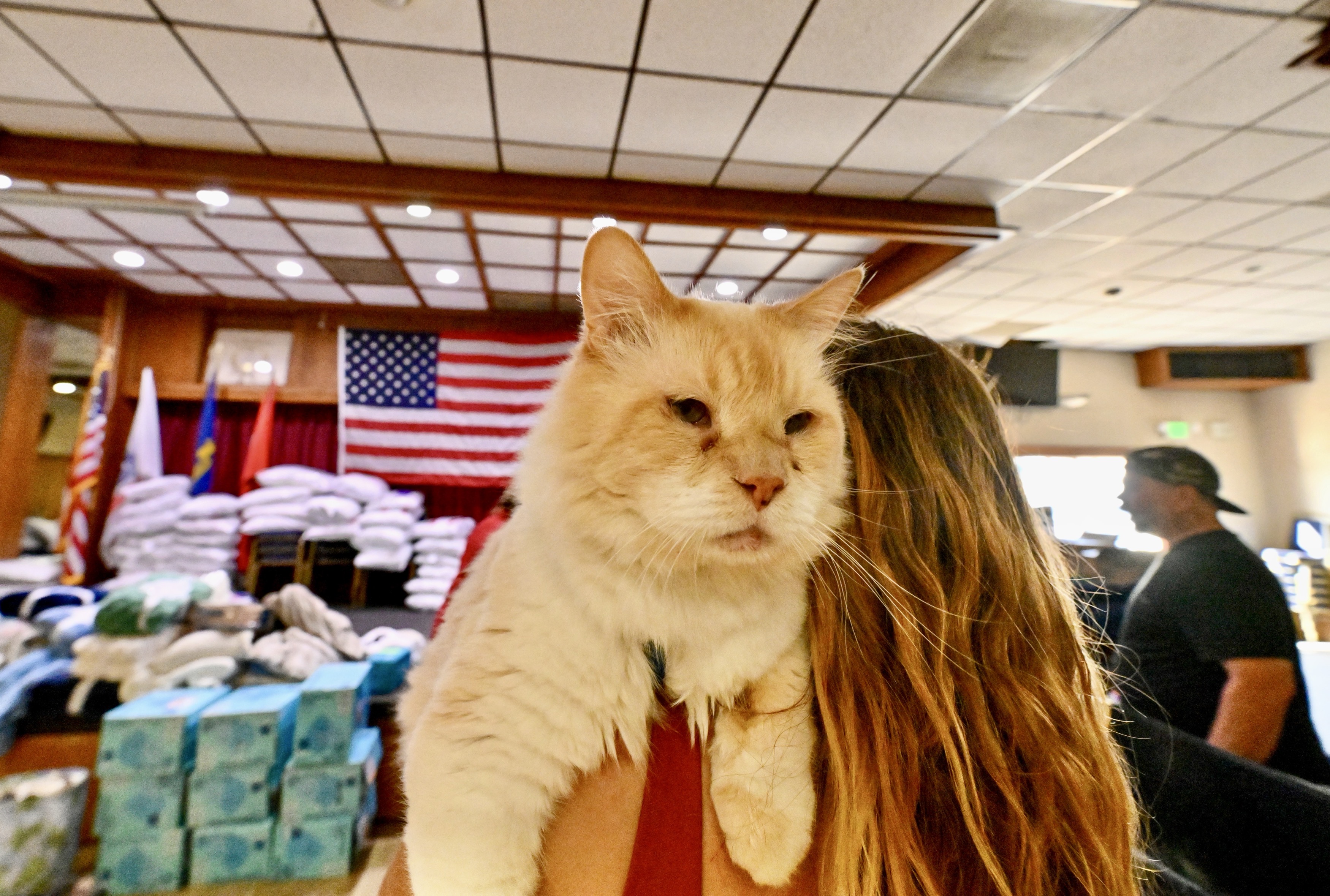 Evacuees Frances Rodriguez holds on to her cat, Rajah at...