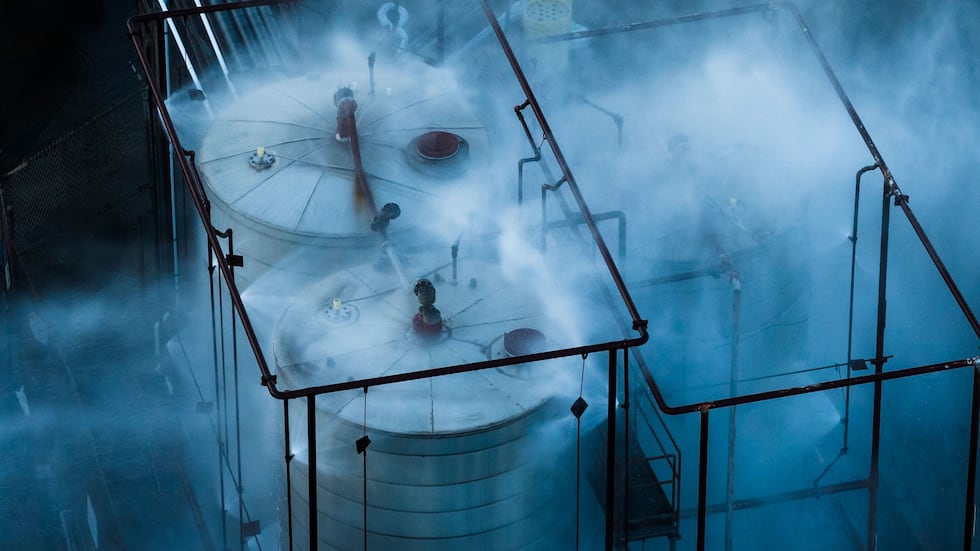 Water is sprayed on a tank that overheated at an aerospace plant in Garden Grove, Calif.,...
