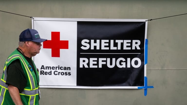 An American Red Cross volunteer walks outside Freedom Hall, an...