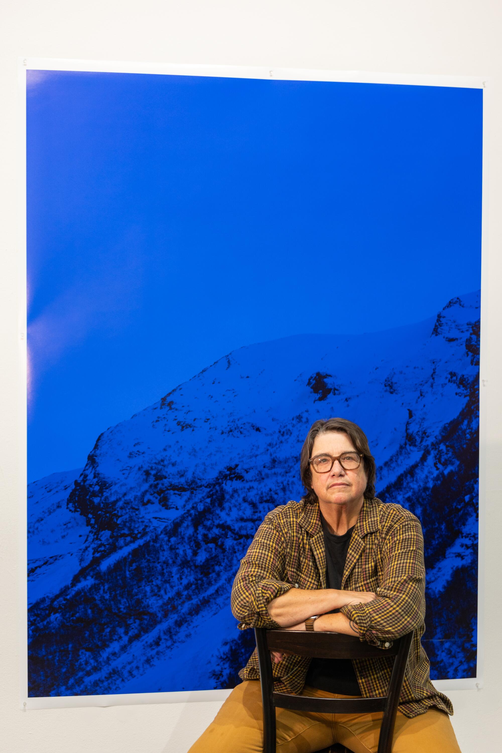 A photographer with her work.