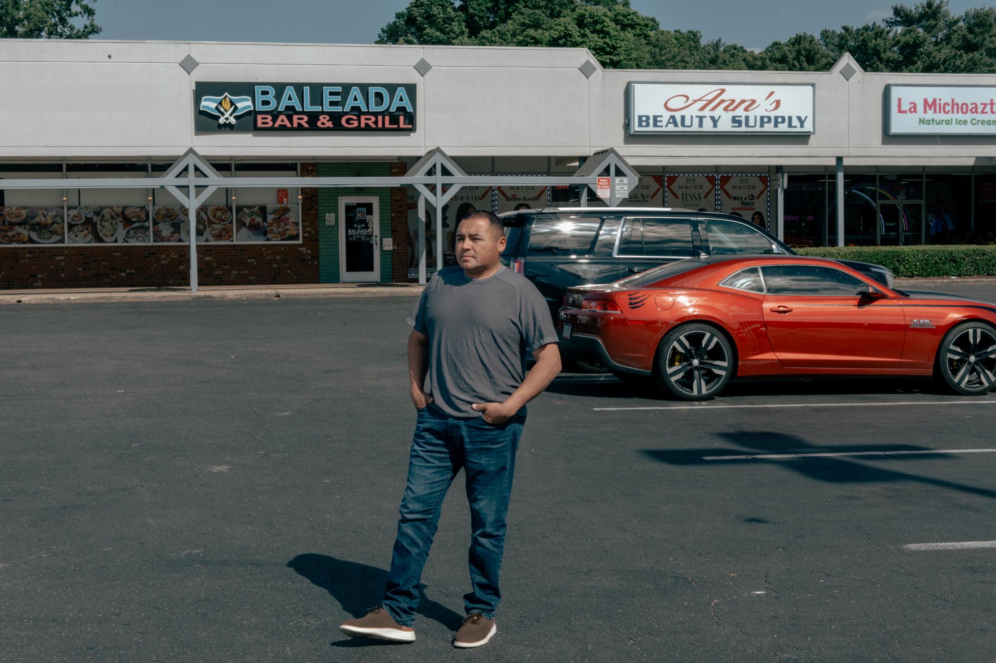 Willy Wender Aceituno stands in a parking lot.