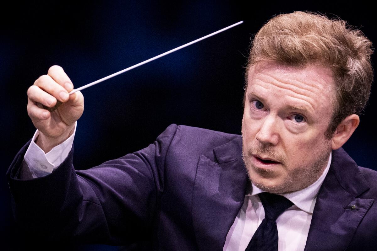 Conductor Daniel Harding raises his baton
