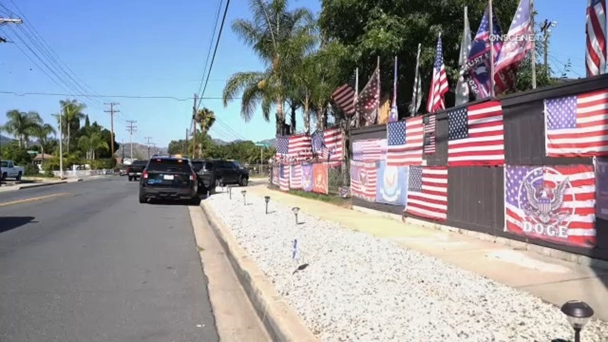 American flags and other pro-Trump banners hang on the side of the property