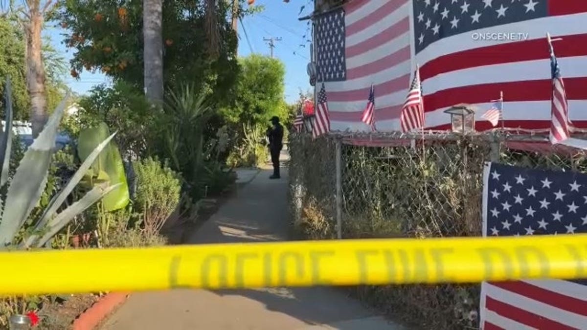 Police tape outside the Escondido home where an elderly man was critical injured and a good Samaritan hurt after intervening in an apparent attack.