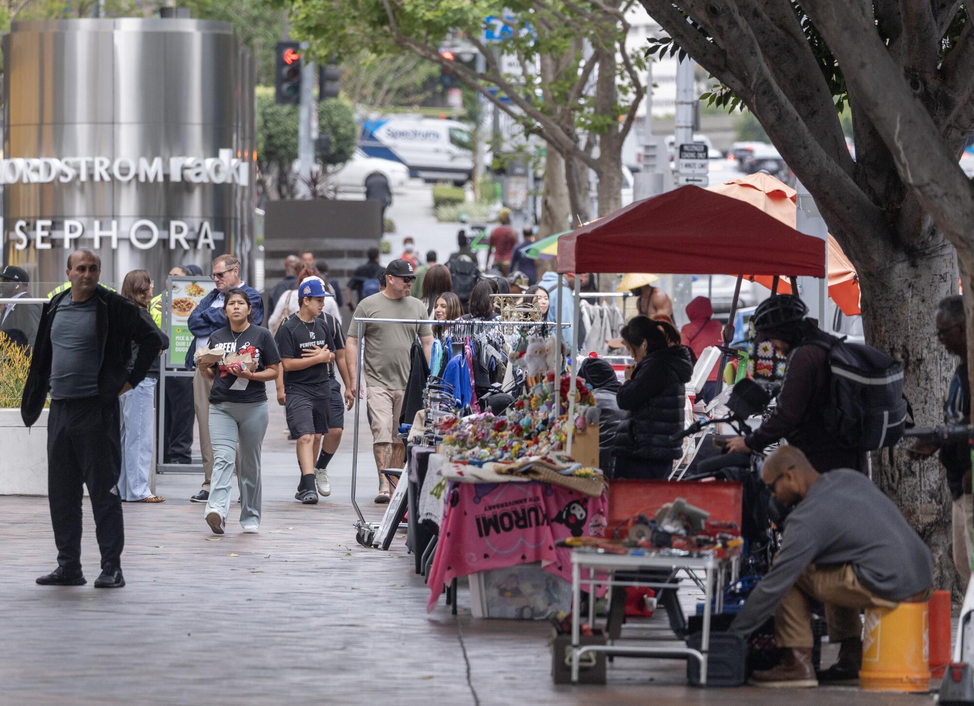 Sidewalk vendors set up May, 12, 2026, on Figueroa Street in front of the Figat7th shopping center in downtown.