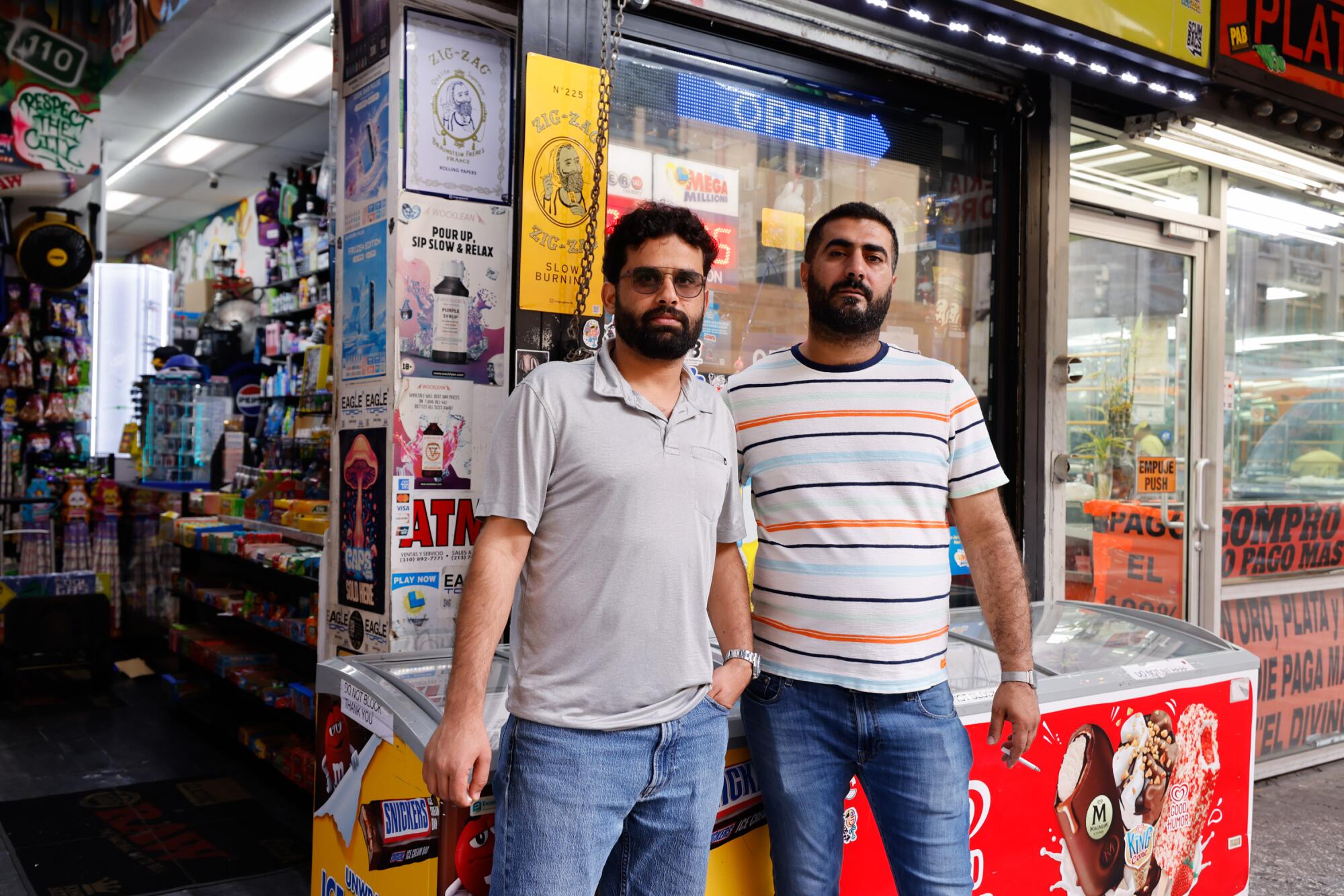 Leo Alareenat, left, and Sam Malkawi, owners of Broadway Market, stand in front of their downtown L.A. store.